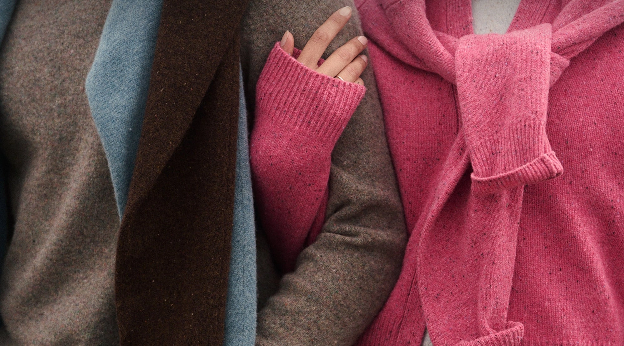 Two friends in layered wool knits on the California coast